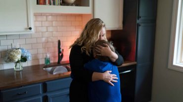 Woman hugs child