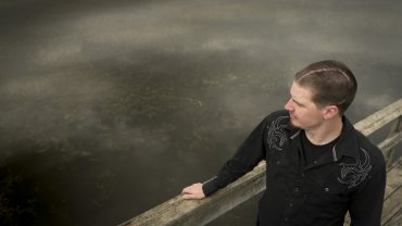 Man standing by lake